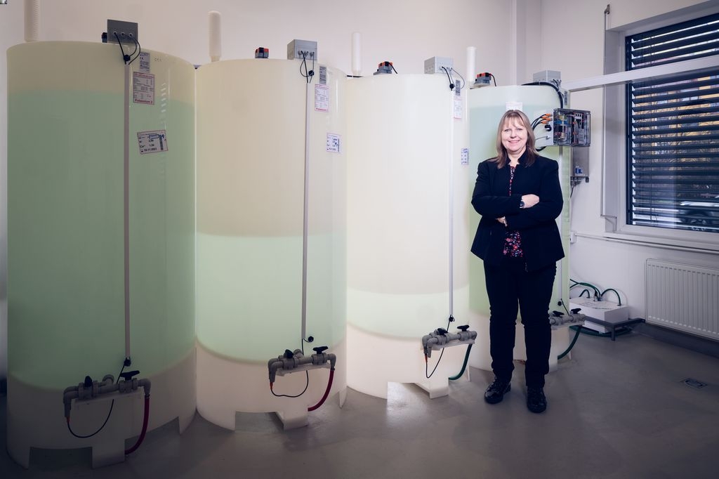 Jitka Pancířová, global quality manager for dialysis at B. Braun stands in front of the tanks where the dialysis fluid mixed on site is stored.