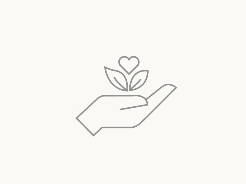 An icon depicting a hand holding a plant, symbolizing sustainability